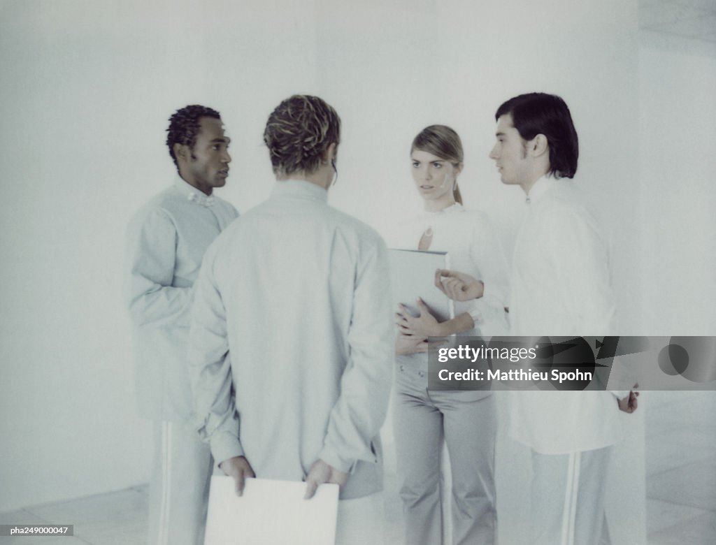 Four people in a room, talking