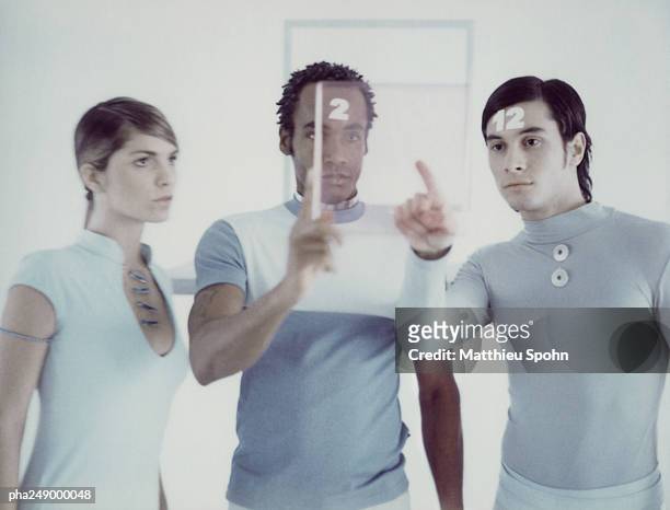 three people looking at square frame - being watched stockfoto's en -beelden