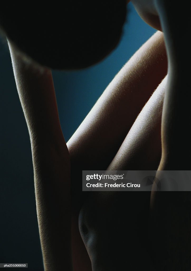 Nude woman leaning forward, high angle view, close-up