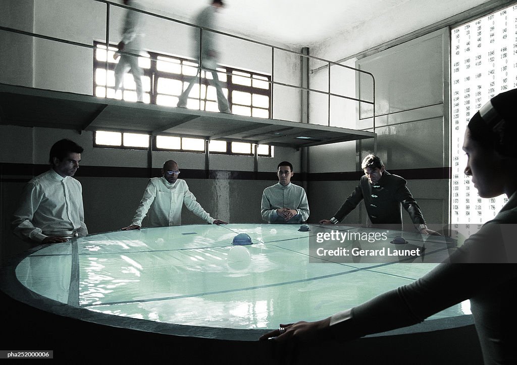 People standing around table