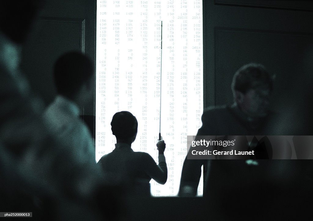 Silhouette of people holding a stick