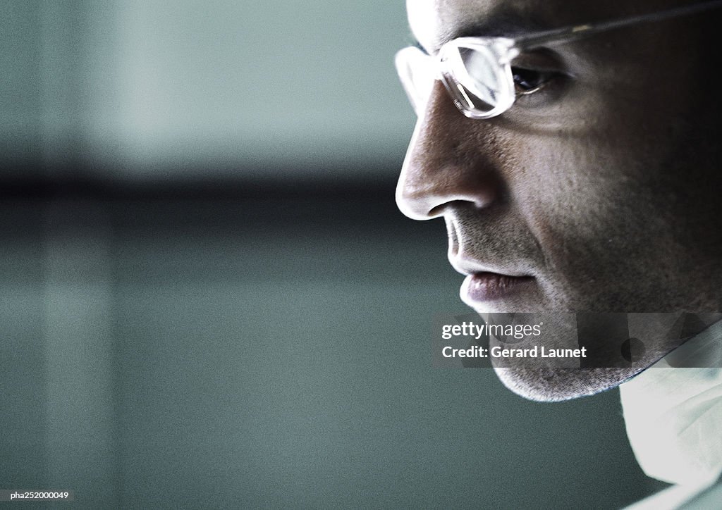 Mature man wearing glasses, close-up, side view