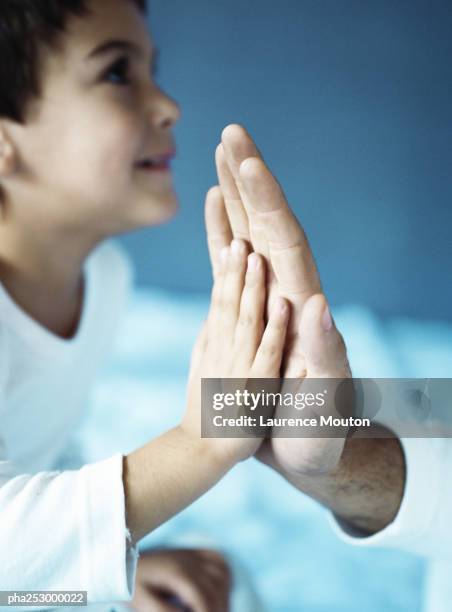 child slapping adult's hand in a high five, close-up - slapping head stock pictures, royalty-free photos & images