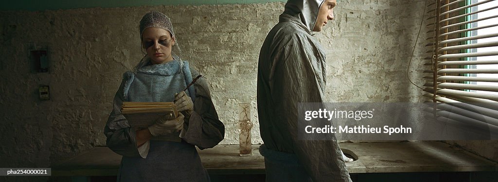 Man and woman writing on notepad