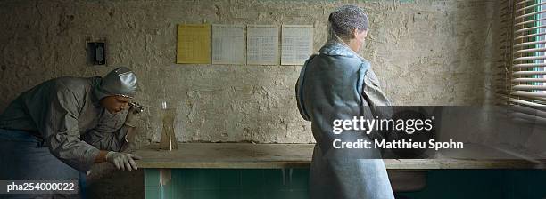 two people in a room - being watched stockfoto's en -beelden