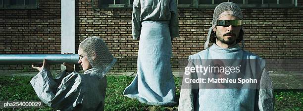 man wearing glasses, woman holding metallic tube - tunic stock pictures, royalty-free photos & images