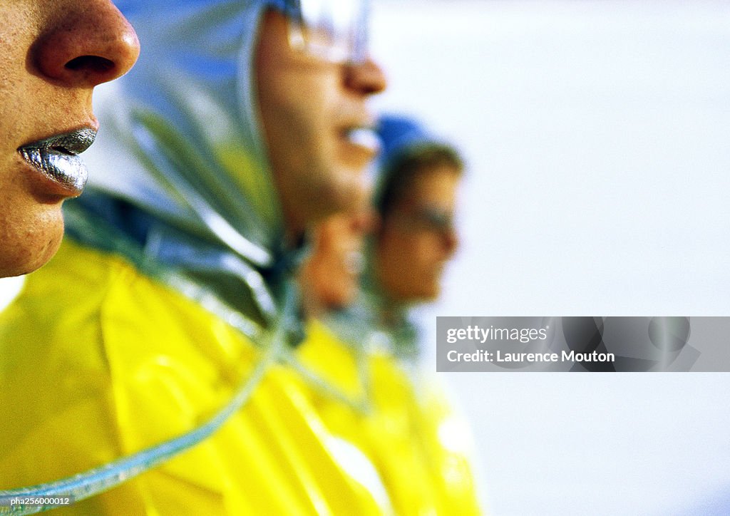 People wearing protective suits, focus on woman's lips