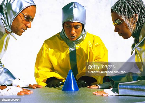 people in protective suits, looking at cone on table - beobachtung stock-fotos und bilder