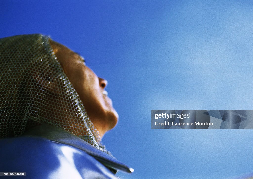 Mature woman looking up, low angle view, close-up