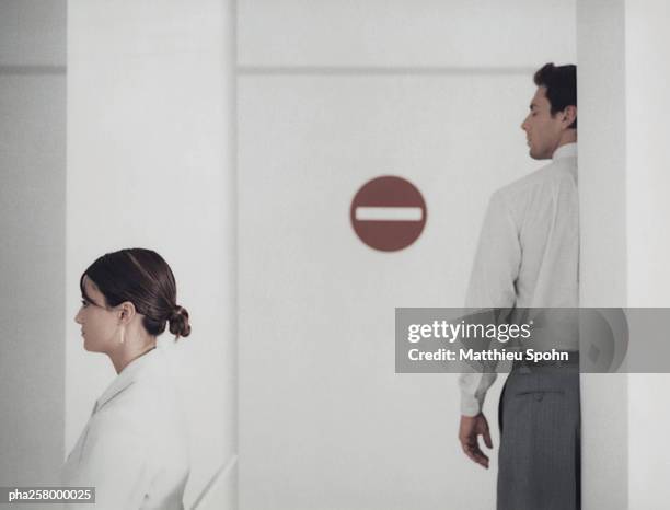 woman and man in office with do not enter sign - why not stock pictures, royalty-free photos & images