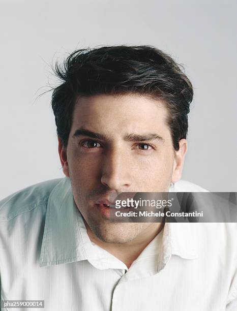 young man leaning, looking at camera - squinting stock pictures, royalty-free photos & images