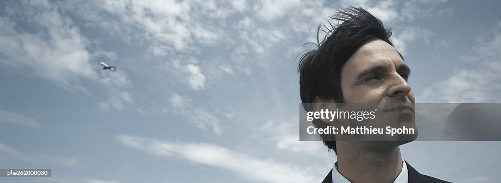 Man's head with sky in background, low angle view