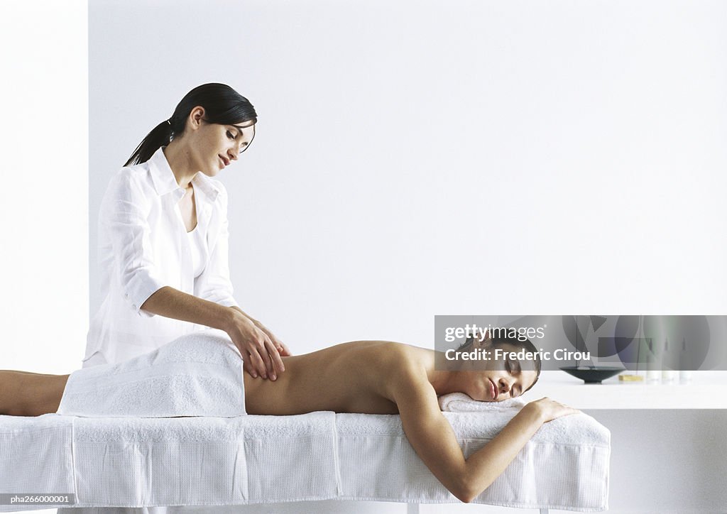 Woman massaging second woman on massage table