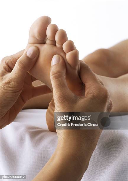 foot massage, close-up - massage table white background stock pictures, royalty-free photos & images