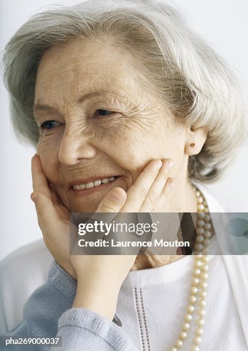 Girl holding grandmother's face Girl holding grandmother's face
