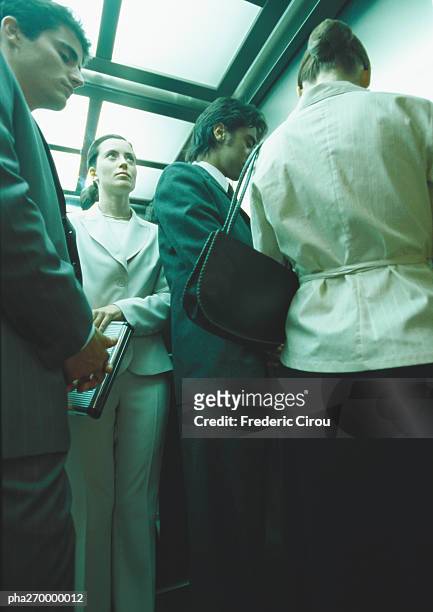 businesspeople in elevator, low angle view - olivia wilde co hosts event at birchbox soho in celebration of conscious commerce birchbox collaboration stockfoto's en -beelden