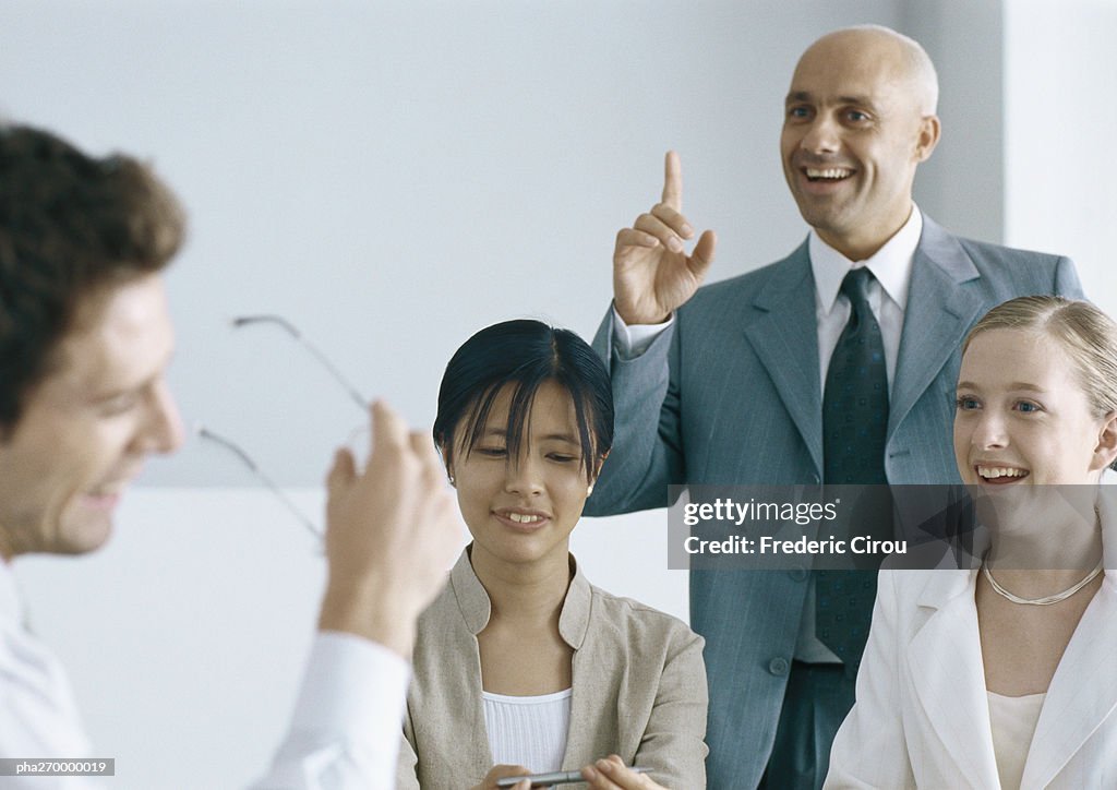 Businesspeople interacting and smiling