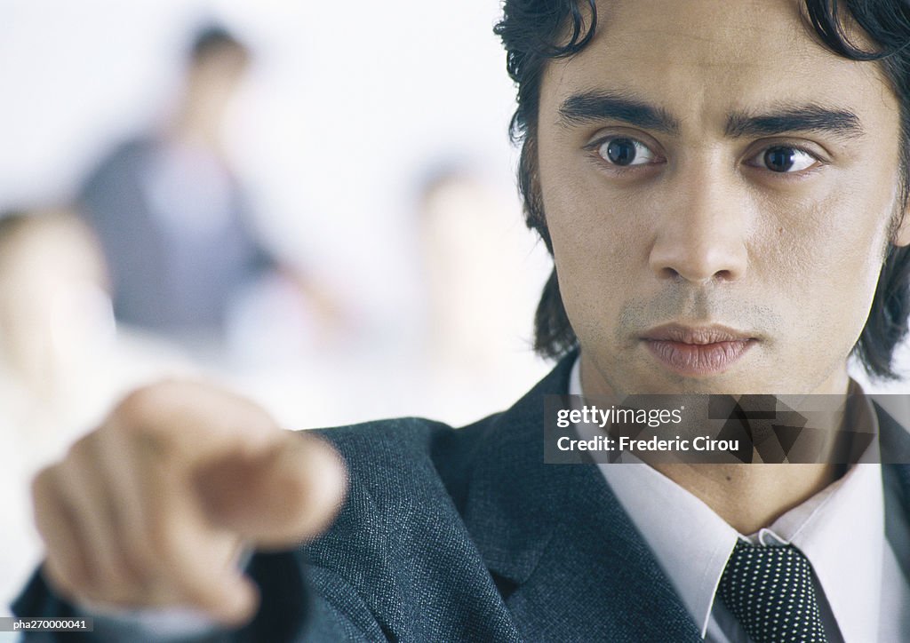 Businessman pointing, close-up