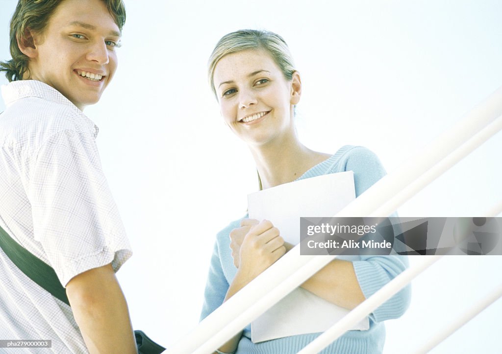 Two students smiling