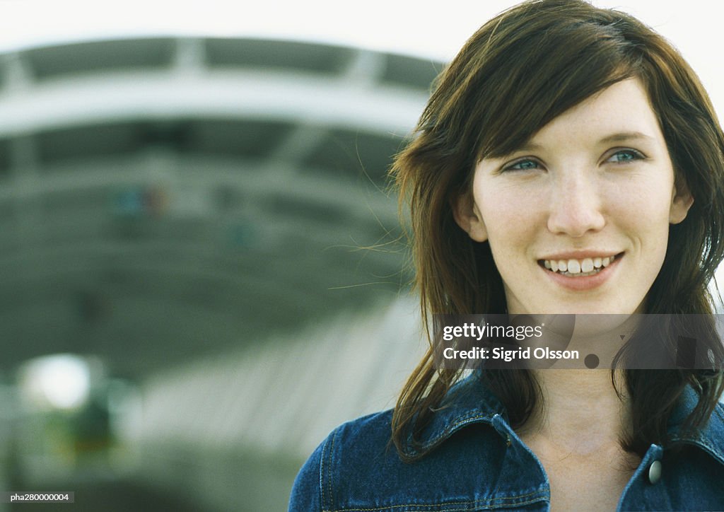 Young woman standing in front of tunnel