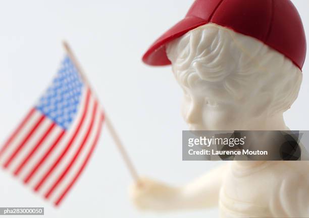 boy figure holding american flag - laurence stockfoto's en -beelden