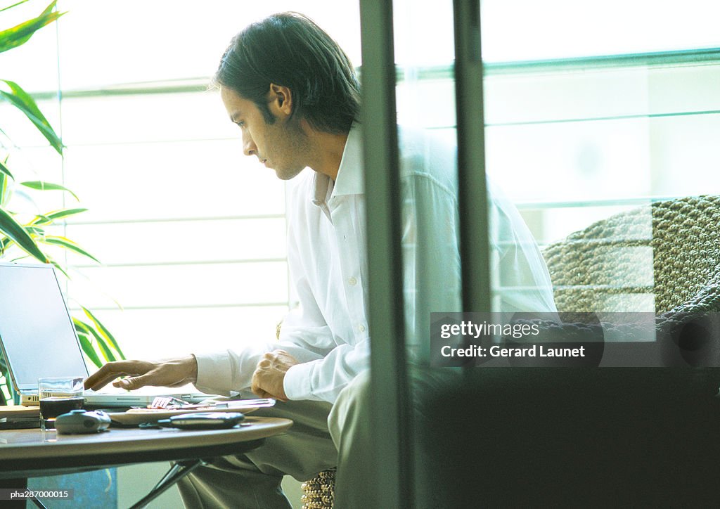 Man using laptop on terrace