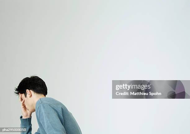 young man covering face with hand - unrecognizable person stock pictures, royalty-free photos & images