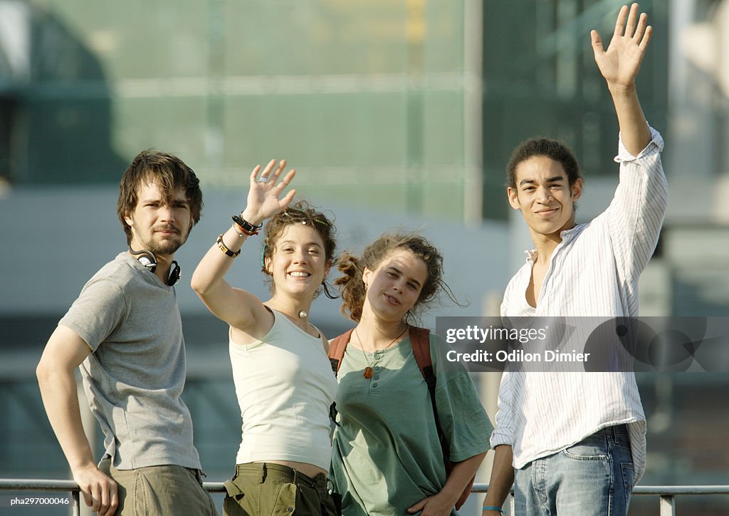 Group of young people waving