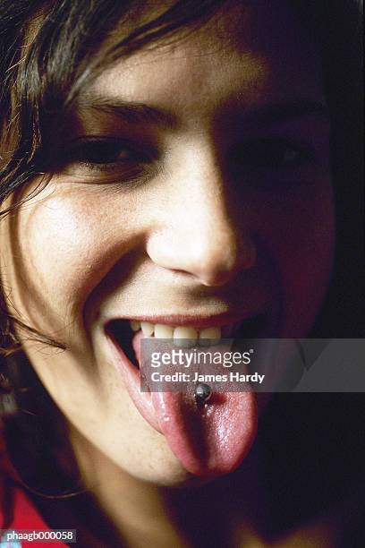 young woman showing tongue piercing - body modification stock-fotos und bilder