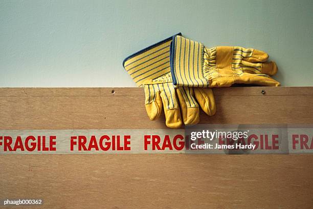 gloves and fragile tape - handle with care stockfoto's en -beelden