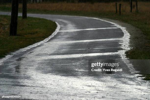 country road during rain shower - yves stock pictures, royalty-free photos & images