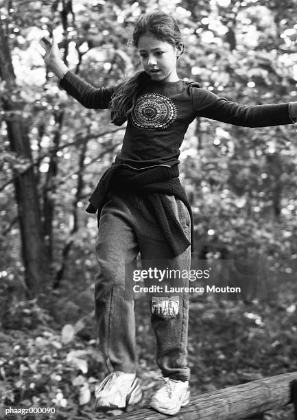 girl walking on log - laurence stockfoto's en -beelden