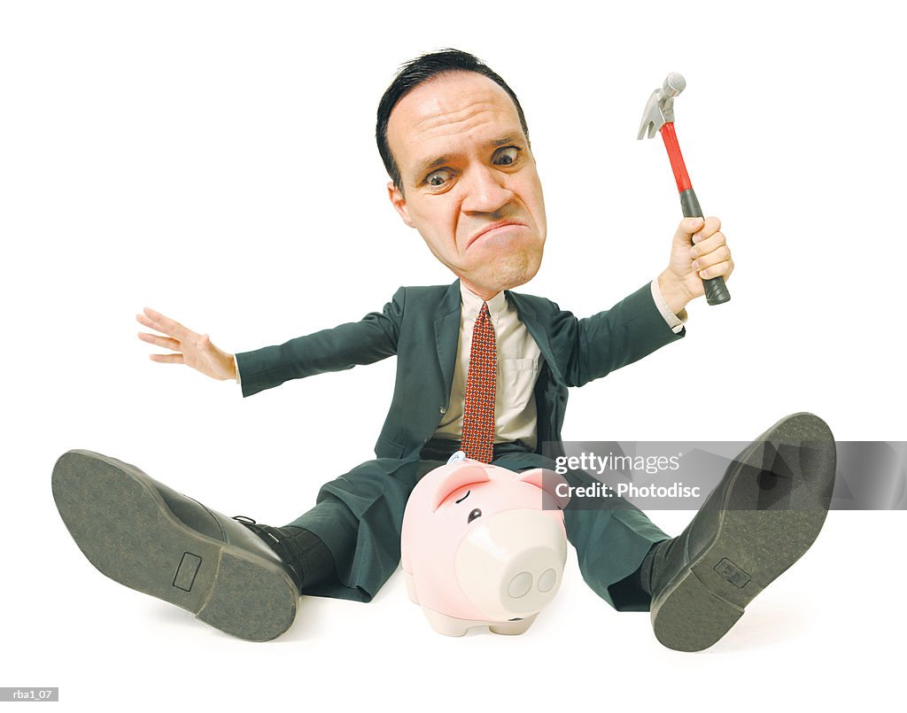 Conceptual caricature of a caucasian man in a suit as he attempts to smash a piggy bank with a hammer