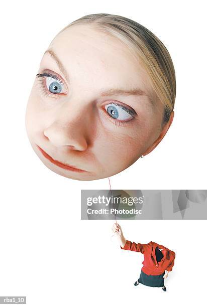 conceptual caricature of a blonde caucasian woman in a red outfit as she hold onto her head by a string as it floats away - estar-en-las-nubes fotografías e imágenes de stock