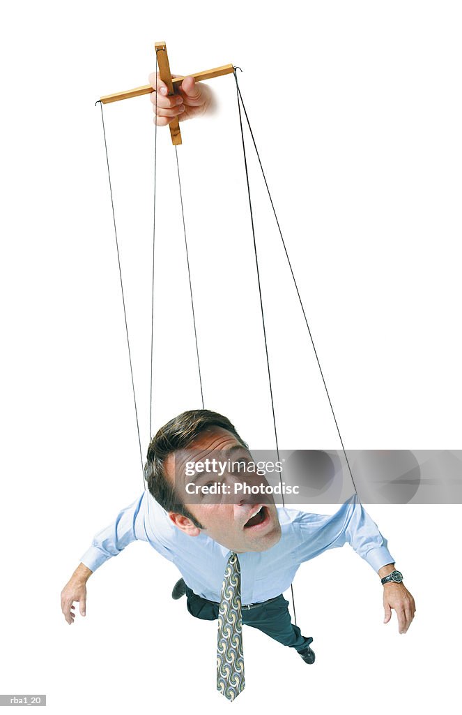 Conceptual caricature of businessman in shirt tie hangs in air by strings as a marionette puppet