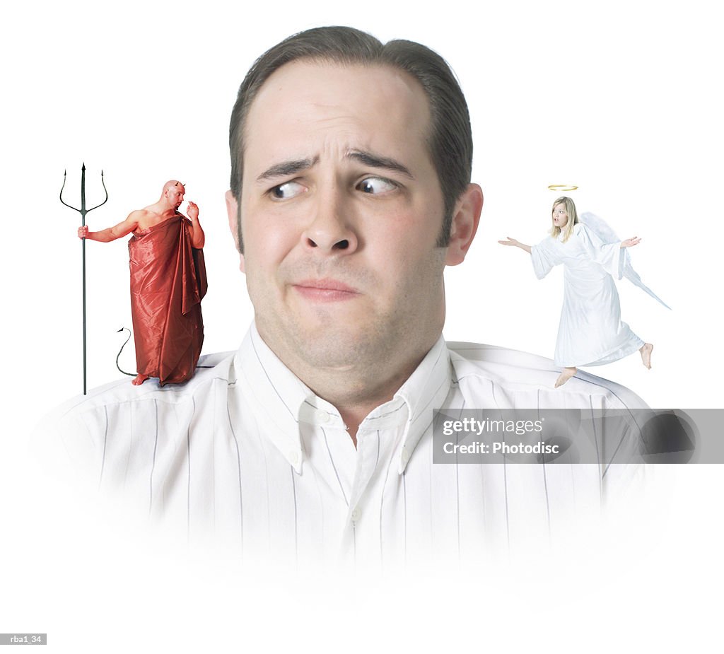 Conceptual photo of a caucasian man with an angel and a devil on his shoulders as he confusedly glances to the devil