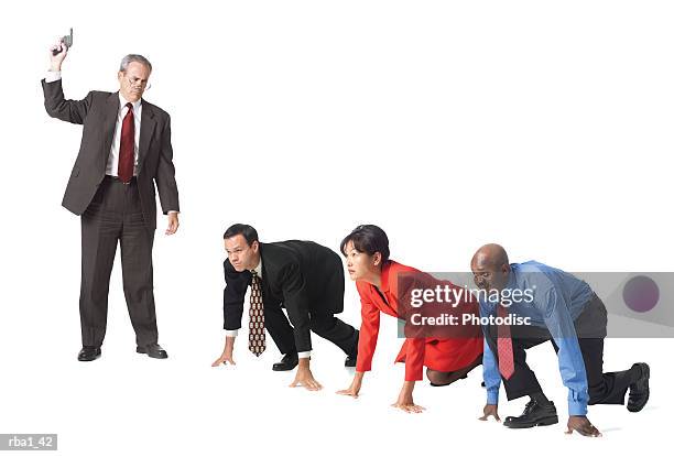 group of business people at the starting block of a race prior to the boss firing the starter pistol - starter pistol stock pictures, royalty-free photos & images