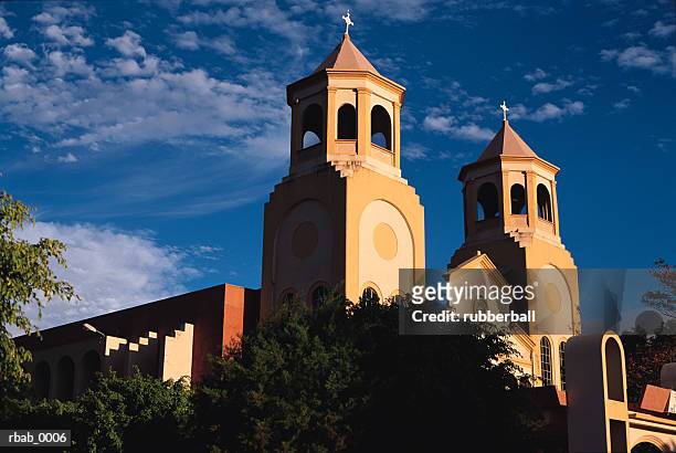 a catholic church in san antonio de belen in costa rica stands silhouetted by a blue sky - costa stock pictures, royalty-free photos & images