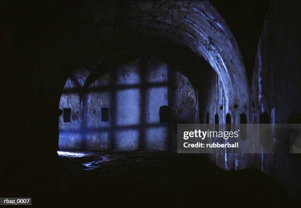 a dark castle hallway filled with eerie shadows - keep imagens e fotografias de stock