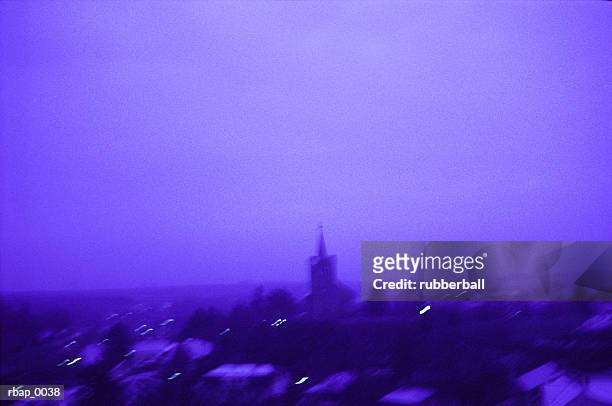 a horizontal photograph of a blue tinted euopean town skyline - town imagens e fotografias de stock
