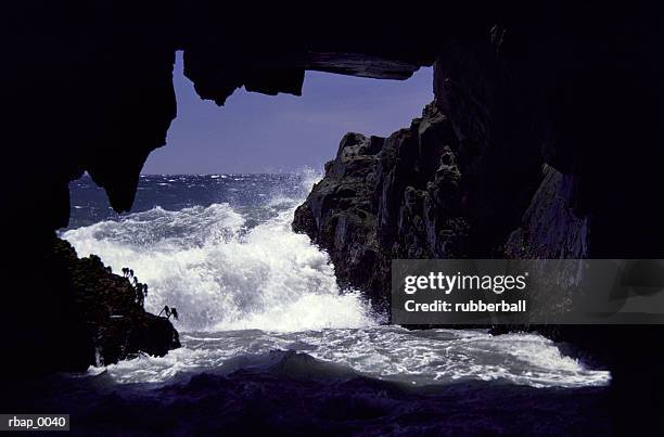 waves of the ocean spill into the mouth of a cove - the cove stock pictures, royalty-free photos & images