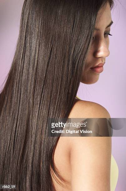 A Young Attractive Ethnic Girl With Beautiful Long Dark Hair Looks Down  Past Her Shoulder High-Res Stock Photo - Getty Images