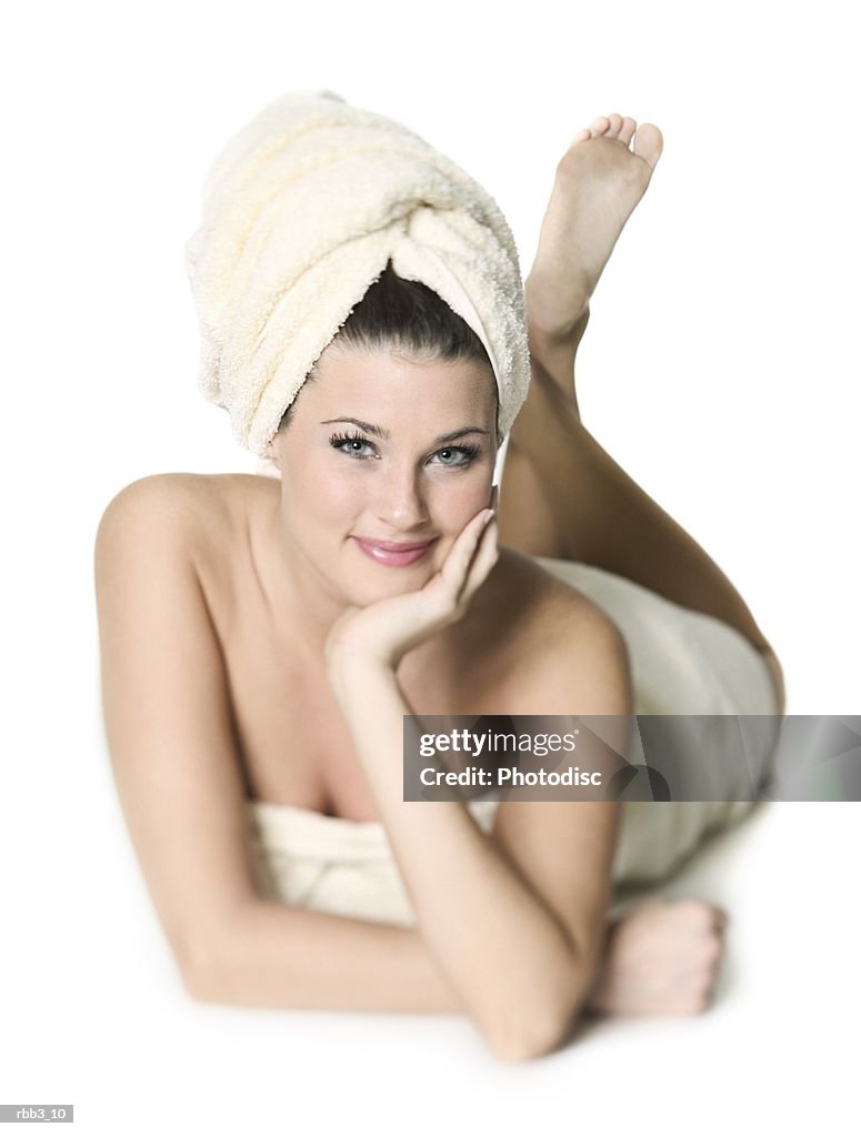 Full body portrait of a young caucasian woman wrapped in a towels