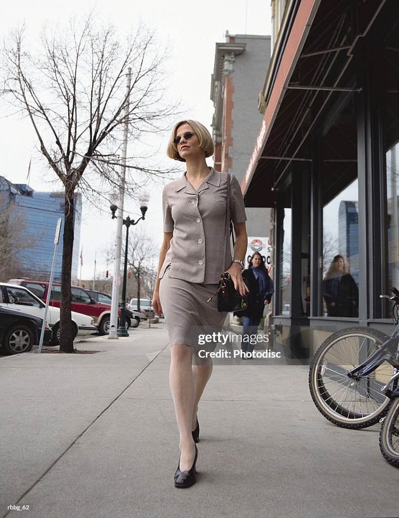 Blonde business woman with short hair and wearing sun glasses