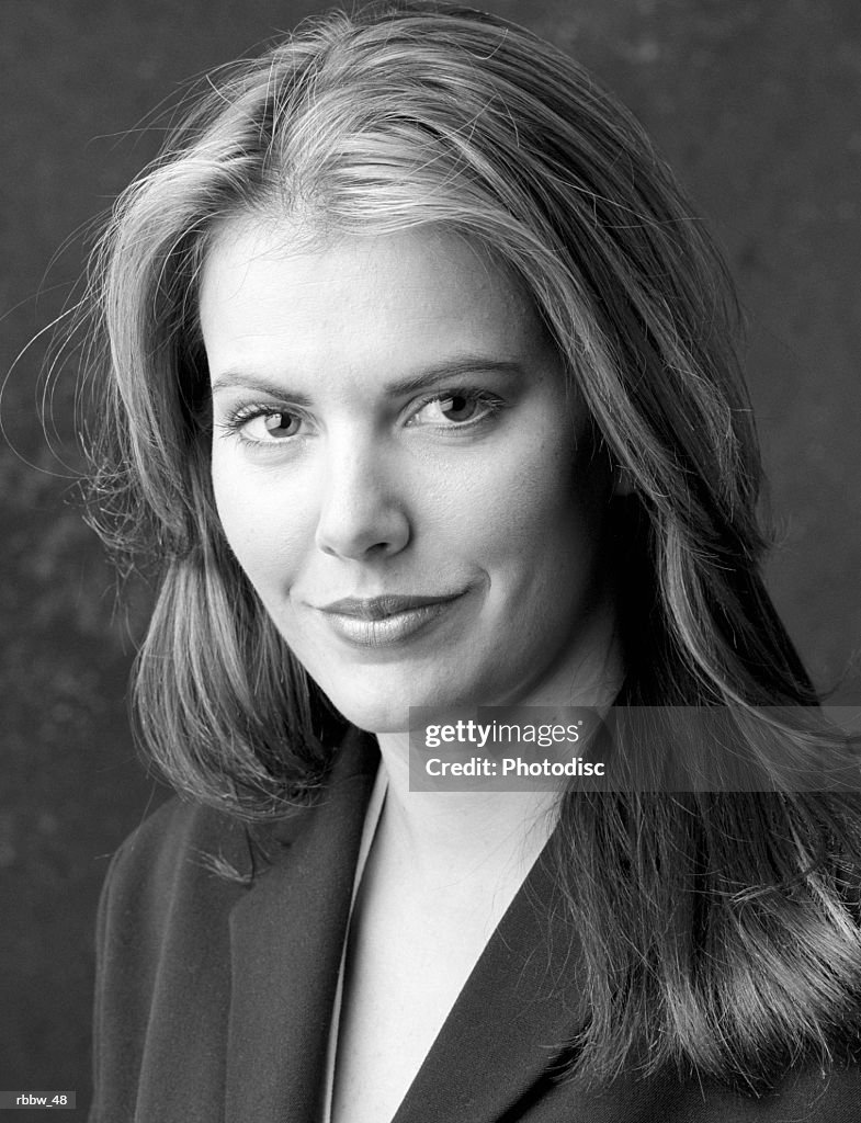 A pretty caucasian woman with long hair gives a serious glance