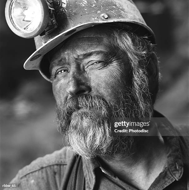 a close up of a gruff caucasian coal miner - coal miner stock-fotos und bilder