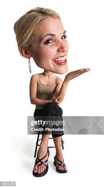photo caricature of a young caucasian blonde woman in black pants and taupe tank top sits down and smiles as she outstretches her hand - pants down bildbanksfoton och bilder