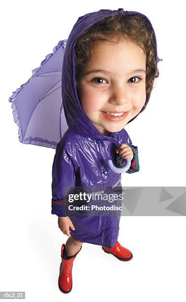 photo caricature from a birdseye view of a little girl wearing  here purple raincoat and red galoshes, and holding her purple umbrella - ehre stock pictures, royalty-free photos & images