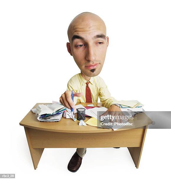 a young bald caucasian man in a yellow shirt and red tie sits at his desk as he looks off into space and daydreams - soul patch stock pictures, royalty-free photos & images