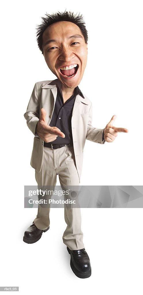 A young asian male points his fingers like guns and has huge smile on his face